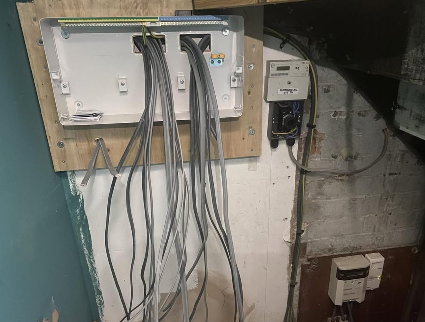 Empty consumer unit enclosure with circuit cables hanging ready to terminate