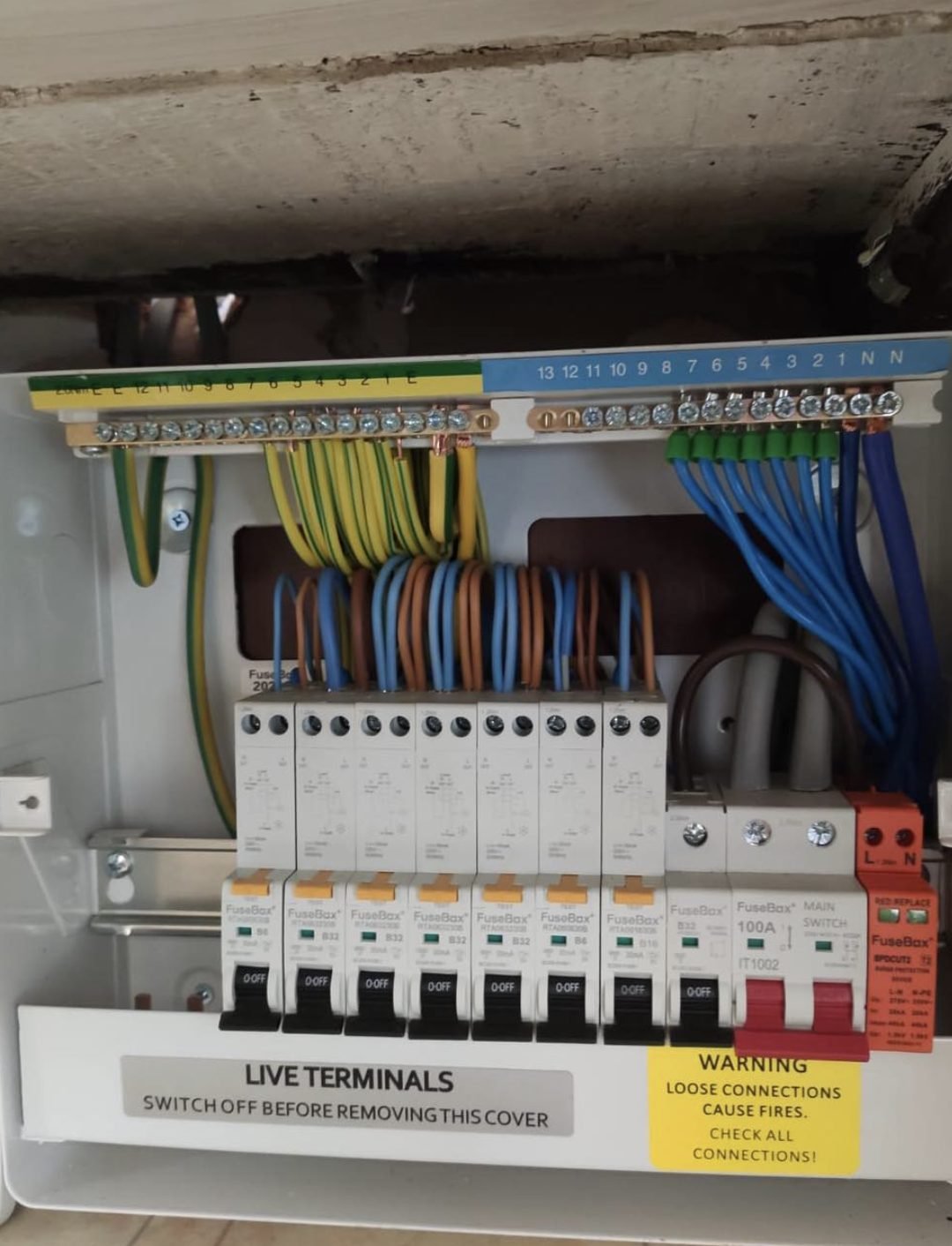 Consumer unit installed beneath a concrete lintel