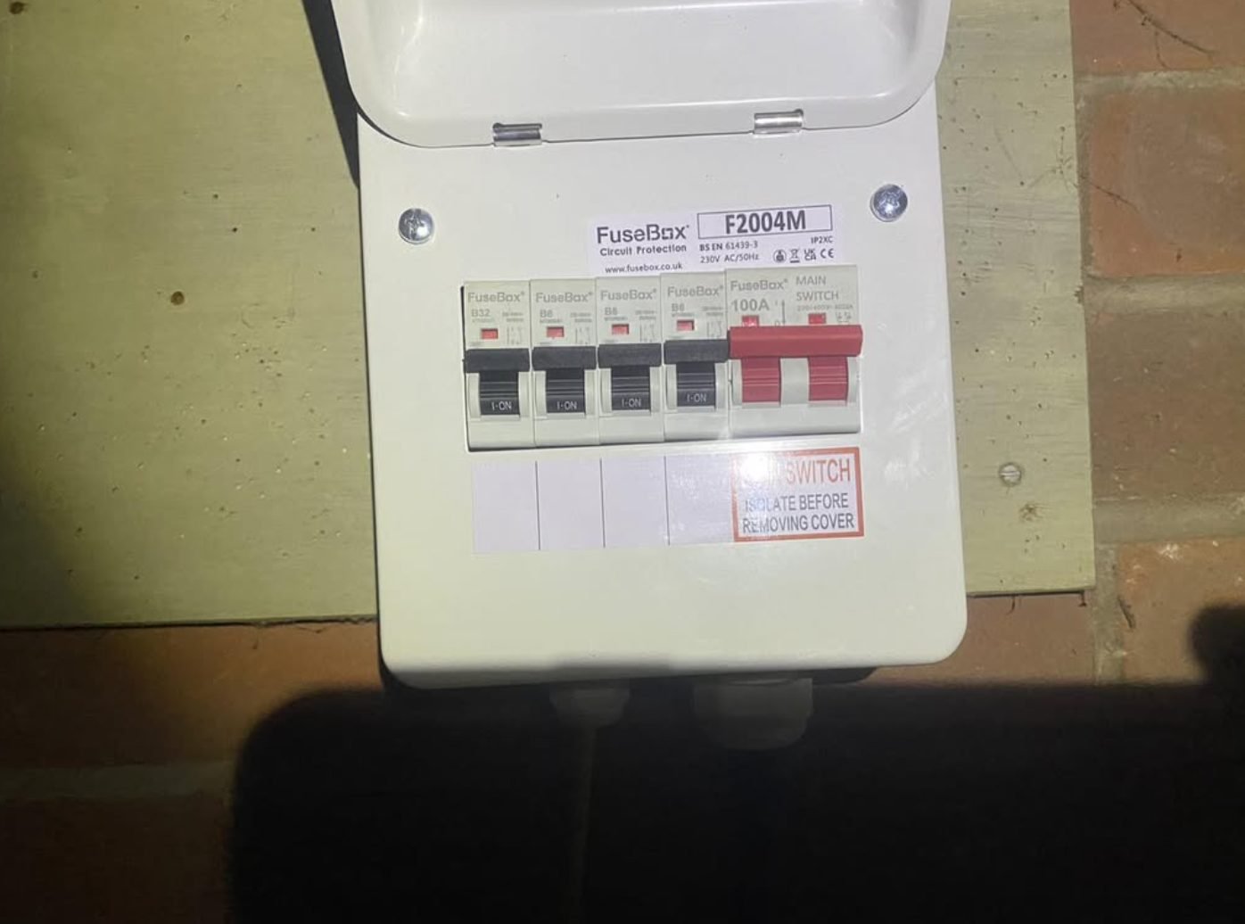 Small four-way consumer unit installed in a garage