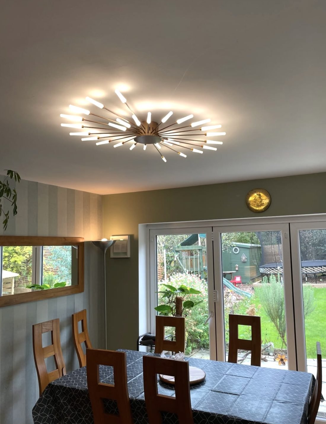 Starburst LED ceiling light fitted above a dining table